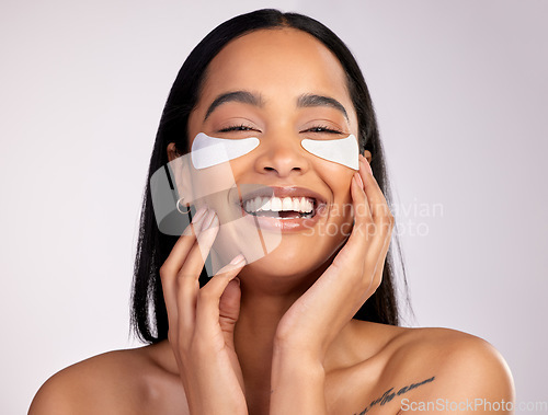 Image of Happy woman, portrait smile and eye mask in skincare, collagen or dermatology against a grey studio background. Face of female person or model smiling in beauty cosmetics, patches or facial treatment