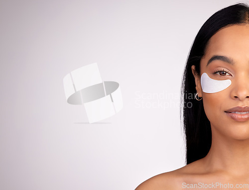 Image of Woman, portrait and eye patches on mockup for skincare, beauty or dermatology against a grey studio background. Happy female person or model with patch under eyes in healthy wellness on mock up space