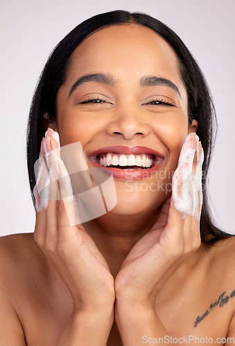 Image of Happy woman, portrait and soap in face wash for skincare hygiene, cleaning or dermatology against a grey studio background. Female person with smile for clean facial treatment, self care or love