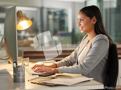 Image of Computer, typing and business woman for research report, copywriting or online planning in night office. Happy editor, journalist or professional agency person working or editing article on desktop