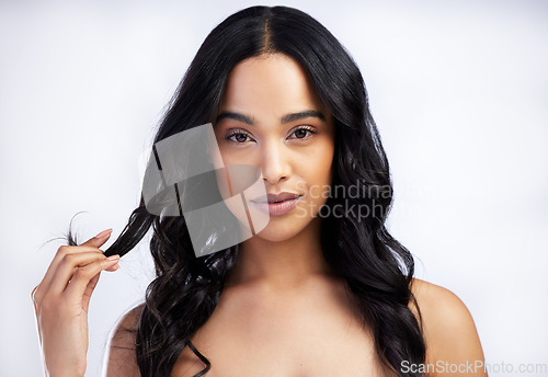 Image of Serious, face and curly hair care of woman in studio isolated on white background for skincare. Portrait, haircare or female model in natural makeup, cosmetics or salon treatment for beauty hairstyle