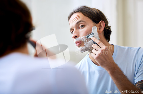 Image of Man shave face in mirror, foam and beauty with morning routine, cosmetic care and grooming at home. Male person in bathroom, hygiene and shaving cream with razor, hair removal and skincare treatment