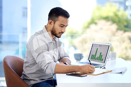 Image of Young business man, writing and notebook with chart, financial planning and data analysis in modern office. Businessman, book and notes with laptop, graph and analytics for investing in workplace