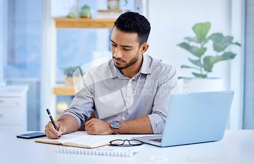 Image of Young business man, writing and book with laptop, notes or schedule planning at web design job. Businessman, notebook and computer with ideas, brainstorming or problem solving for report in workplace