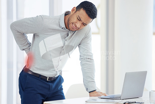 Image of Businessman, laptop and back pain in burnout, stress or inflammation and mental health by office desk. Fatigue or tired man with painful area from accident, rear ache or bad posture at the workplace