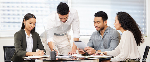 Image of Business people, meeting and tablet work planning a digital strategy in a workshop with teamwork. Working, employee group and startup management with notes and paperwork in a office with web design