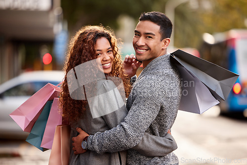 Image of Happy couple, portrait smile and shopping bags in city together for fashion, gift or buying outdoors. Man and woman in relationship smiling for customer discount, purchase or payment in urban town