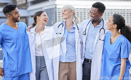 Image of Doctor team, city and laugh with hug and happiness from healthcare and wellness work. Hospital, nursing and happy clinic group with funny joke and support together by an urban building with a smile