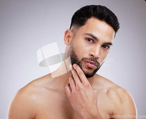 Image of Skincare, beauty and portrait of man in a studio with a natural, grooming and face routine. Self care, beard trim and male model with a dermatology facial treatment for clear skin by gray background.