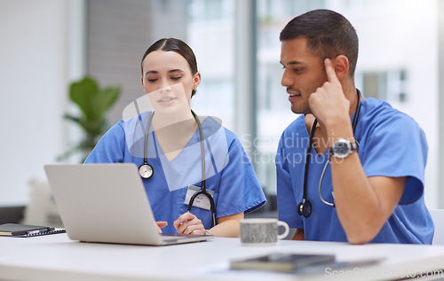 Image of Teamwork, laptop and medical with doctors in hospital boardroom for planning, research and help. Medicine, healthcare and collaboration with man and woman for strategy, internet and meeting