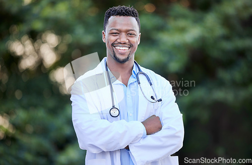 Image of Black man, doctor portrait and arms crossed of healthcare and wellness professional outdoor. Success, motivation and African male person in nature with a smile from career confidence and work