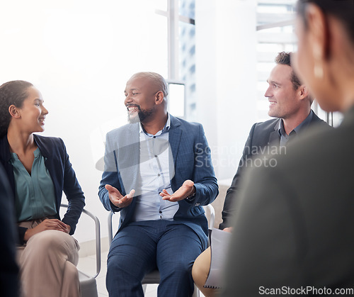 Image of Business, meeting and black man in discussion circle at office for team building, planning and collaboration. Group, diversity and happy management in a huddle for conversation, workshop and training