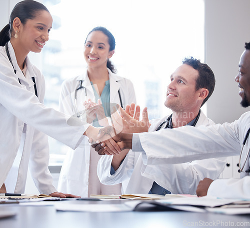Image of Doctors, staff or meeting with handshake, applause or congratulations with healthcare innovation, wellness or opportunity. Group, team or coworkers clapping, shaking hands or partnership with growth