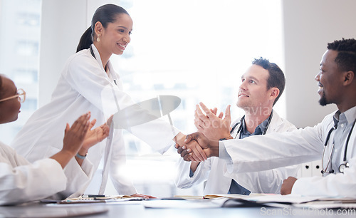 Image of Doctors, staff and meeting with handshake, applause or promotion with healthcare innovation, growth or opportunity. Group, team or coworkers brainstorming, clapping or shaking hands with medical cure