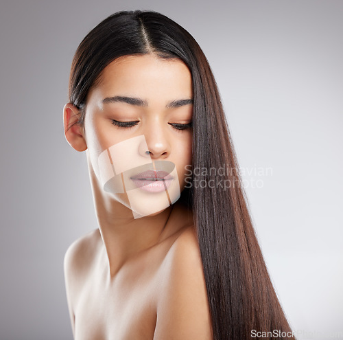 Image of Hair, haircare and woman with beauty and salon hairstyle, Brazilian or keratin treatment isolated on studio background. Female model with growth, shine and glossy with cosmetic care and elegance