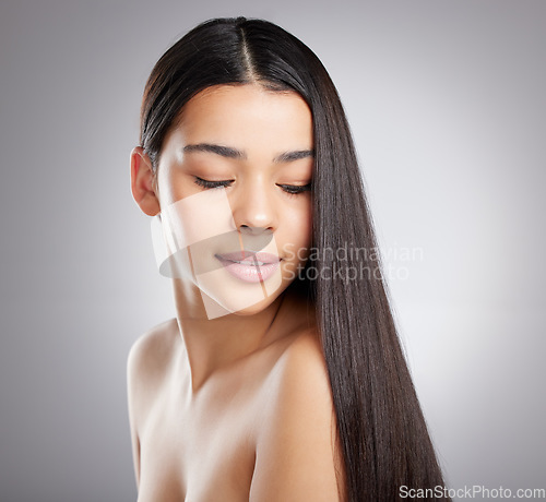 Image of Hair care, woman with beauty and salon hairstyle, Brazilian or keratin treatment isolated on studio background. Female model with growth, shine and glossy with cosmetic care glow and elegance