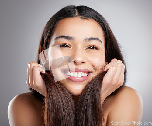 Image of Portrait, beauty and woman with hair care, smile and luxury treatment against a grey studio background. Face, female person or happy model with grooming routine, happiness and clean scalp with volume