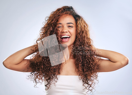 Image of Woman, natural hair and curly hairstyle in studio with smile and face glow. Portrait of African person with healthy curls and growth as benefits or results of shampoo or cosmetics on white background