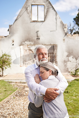 Image of Couple, home in ruins after fire and hug at accident, disaster or crisis with hope and support with insurance. Property, senior man and woman hugging outside burned house, grief and real estate loss