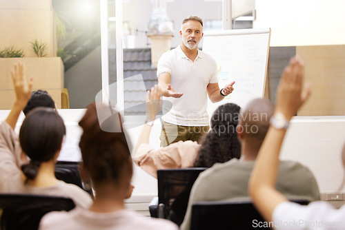 Image of Presentation, staff and man in a conference room, teamwork and questions for company training. Male person, leader and group in a workshop, speaker and manager with support, meeting and solidarity