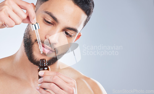 Image of Mockup, serum and man with skincare, cosmetics and dermatology against a grey studio background. Male person, model and guy with oil, beauty and liquid for face, grooming and routine for smooth skin