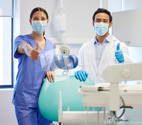Image of Dentist team, face mask and thumbs up portrait for.medical industry and teamwork. Assistant woman and asian man or healthcare staff together for dental care, oral health and wellness at practice