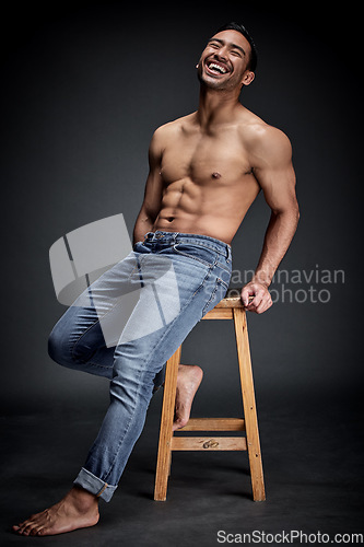 Image of Smile, muscle and man with fitness, wellness and strong model against a dark studio background. Happy male person, humor and guy laughing, chair and muscular with body builder, sexy and workout goal