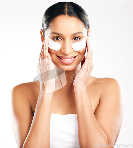 Image of Happy woman, portrait and eye patches for skincare, beauty or cosmetics against a white studio background. Face of female person with facial collagen pads under eyes for anti aging or dermatology