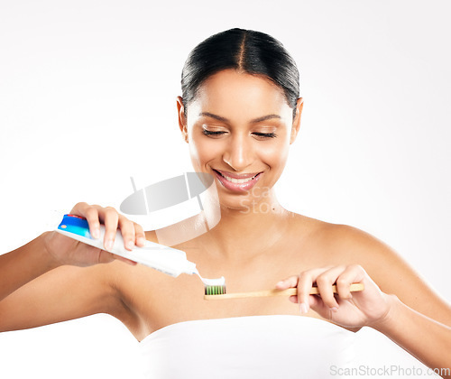 Image of Happy woman, toothbrush and toothpaste for clean teeth, dental or hygiene against a white studio background. Female person or model with product for brushing mouth, oral or gum care on mockup space