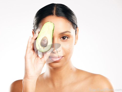 Image of Woman, portrait and avocado on face in skincare, natural beauty or nutrition against a white studio background. Female person or model with organic fruit or vegetable for healthy skin, diet or facial