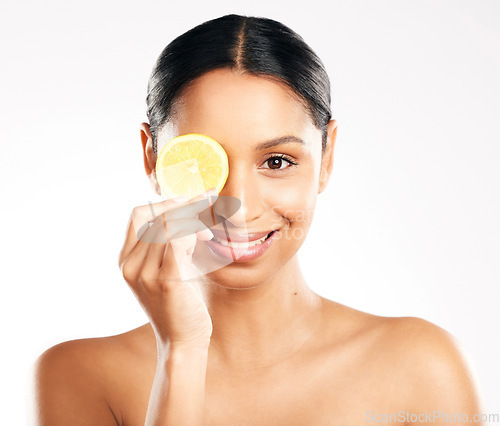 Image of Happy woman, portrait and face with lemon for vitamin C, diet or skincare against a white studio background. Female person smile with citrus fruit for healthy nutrition, natural collagen or facial