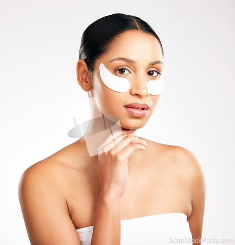 Image of Woman, portrait and eye patches for skincare, beauty or cosmetics against a white studio background. Face of female person or model with facial collagen pads under eyes for anti aging or dermatology