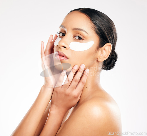 Image of Woman, portrait and eye mask in skincare, cosmetics or beauty against a white studio background. Face of female person or model with facial collagen pads under eyes for anti aging or dermatology