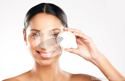 Image of Happy woman, portrait and face cream for skincare, cosmetics or beauty against a white studio background. Female person with container, product or lotion and smile for dermatology or facial treatment