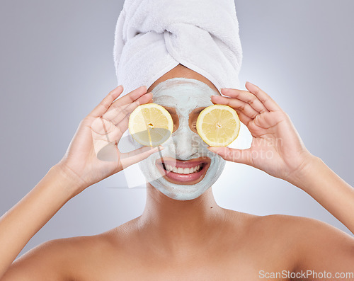 Image of Mask, beauty and lemon with woman in studio for skincare, natural cosmetics and vitamin c. Self care, glow and spa with face of female model and citrus fruit on grey background for detox product