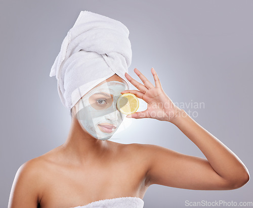 Image of Mask, skincare and lemon with portrait of woman in studio for beauty, natural cosmetics and vitamin c. Self care, glow and spa with female model and citrus fruit on grey background for detox product