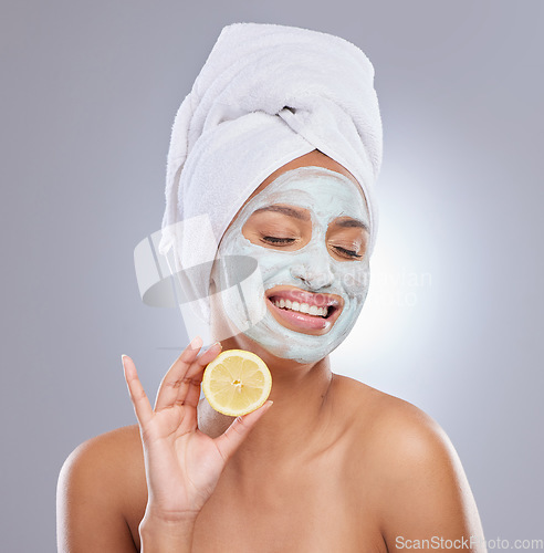 Image of Mask, skincare and lemon with face of woman in studio for beauty, natural cosmetics and vitamin c. Self care, glow and spa with female model and citrus fruit on grey background for detox product