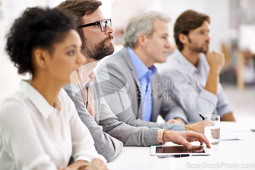 Image of Project debriefing. Shot of a group of dedicated business professionals sitting in a row.