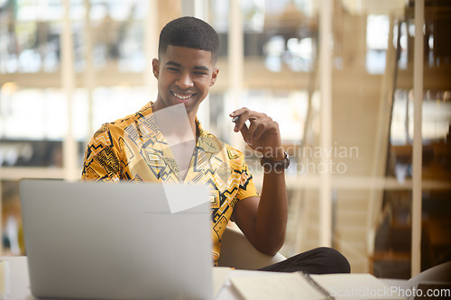 Image of He develops so many amazing ideas all on his own. Shot of a young businessman working on a laptop in an office.