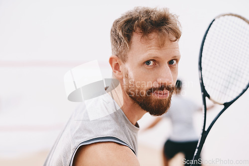 Image of Have my medal ready for me. Portrait of a young man playing a game of squash with his team mate in the background.