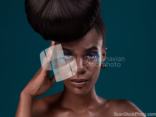 Image of Portrait, hair and makeup with a model black woman in studio on a blue background for beauty. Face, haircare and cosmetics with an attractive young female person at the salon for fashion or styling
