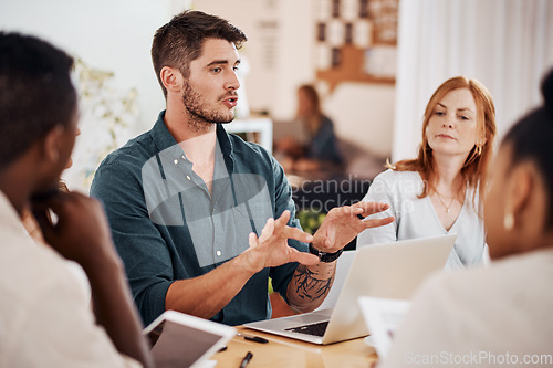 Image of Setting out some clear objectives. Shot of a young businessman having a meeting with his colleagues in an office.