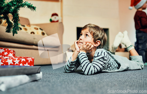 Image of Dear Santa...I promise Ive been good. Shot of an adorable little boy lying down next to the Christmas tree at home.