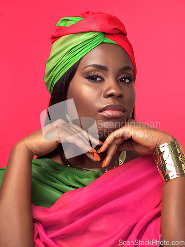 Image of I feel like a queen in this attire. Studio portrait of a beautiful young woman wearing a cultural attire and jewellery against a pink background.