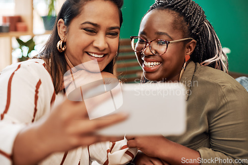 Image of Live for the moments that make fun memories. Shot of two young women taking selfies at cafe.