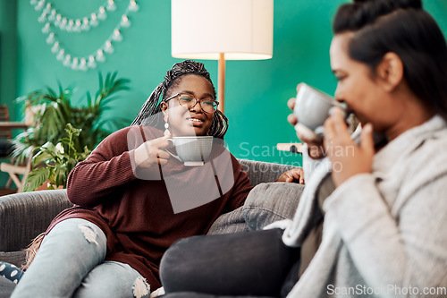 Image of With good coffee comes good conversation. Shot of two young women having coffee and chatting on the sofa at home.