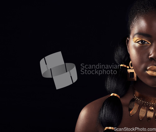 Image of Half, portrait and black woman in studio with gold, luxury and makeup on black background. Glitter, face and African female model with wealth, glow and jewellery, elegance and posing royal aesthetic