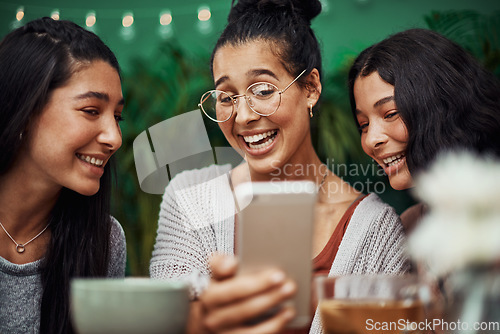 Image of Sisters bring out our best smiles. Shot of young sisters taking selfies together at a cafe.