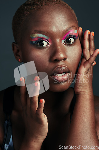 Image of Youre always on fleek if youre wearing color. Cropped shot of a beautiful woman wearing colorful eyeshadow while posing against a grey background.
