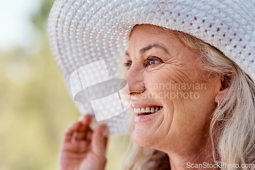 Image of Its the season of smiles. Cropped shot of an attractive senior woman smiling while standing outdoors on a summers day.